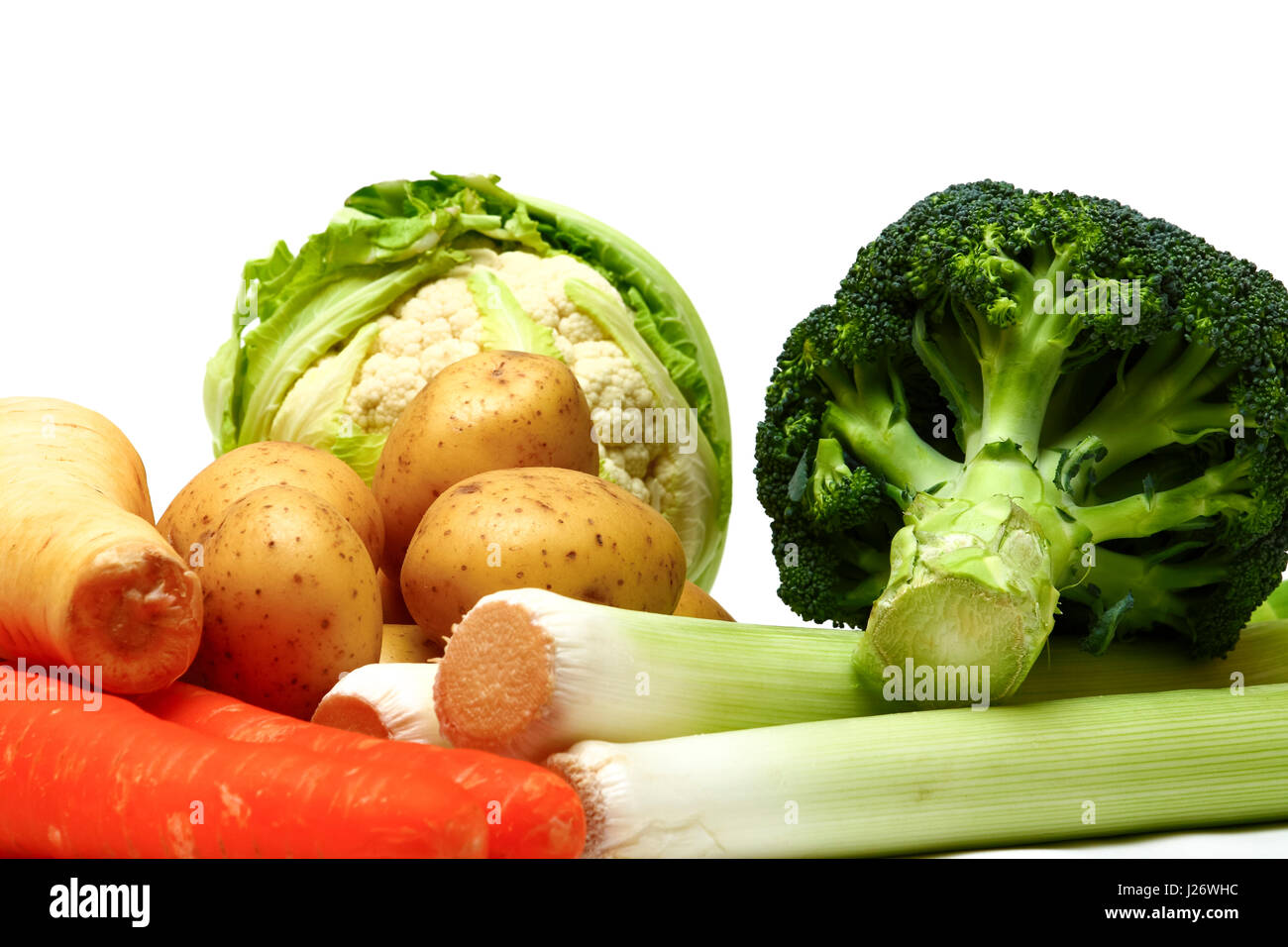 Collection of raw organic root vegetables including potatoes , carrots