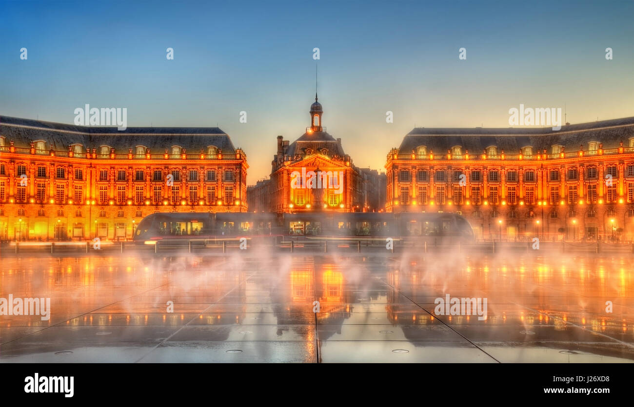 Iconic view of Place de la Bourse with tram and water mirror fountain in Bordeaux - France, Gironde Stock Photo