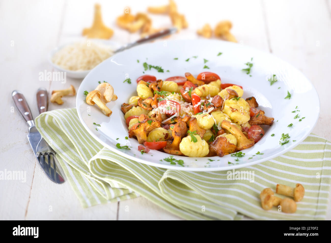 Fresh Italian gnocchi with fried chanterelles, tomatoes, bacon and