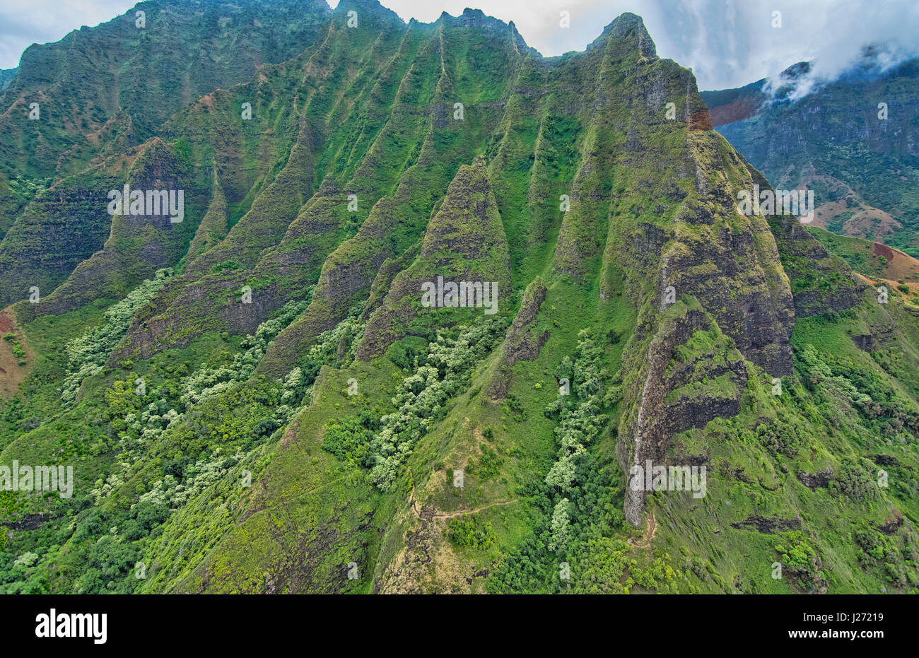 Kauai Hawaii aerial from helicopter of the breath-taking Na Pali coast canyons cliffs Na Pali-Kona Forest Reserve Stock Photo