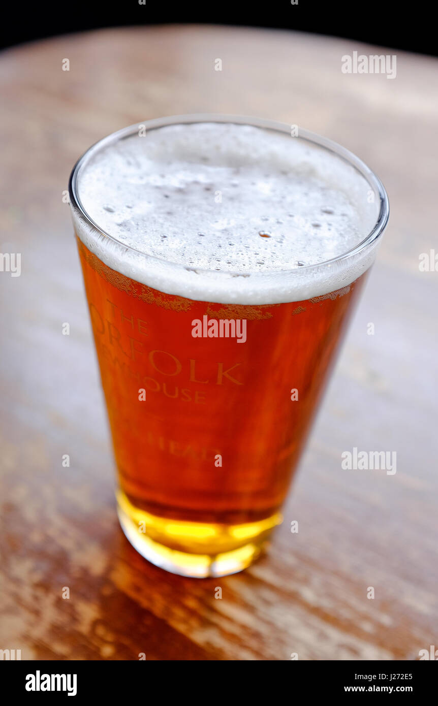 glass of pale ale beer on pub table Stock Photo