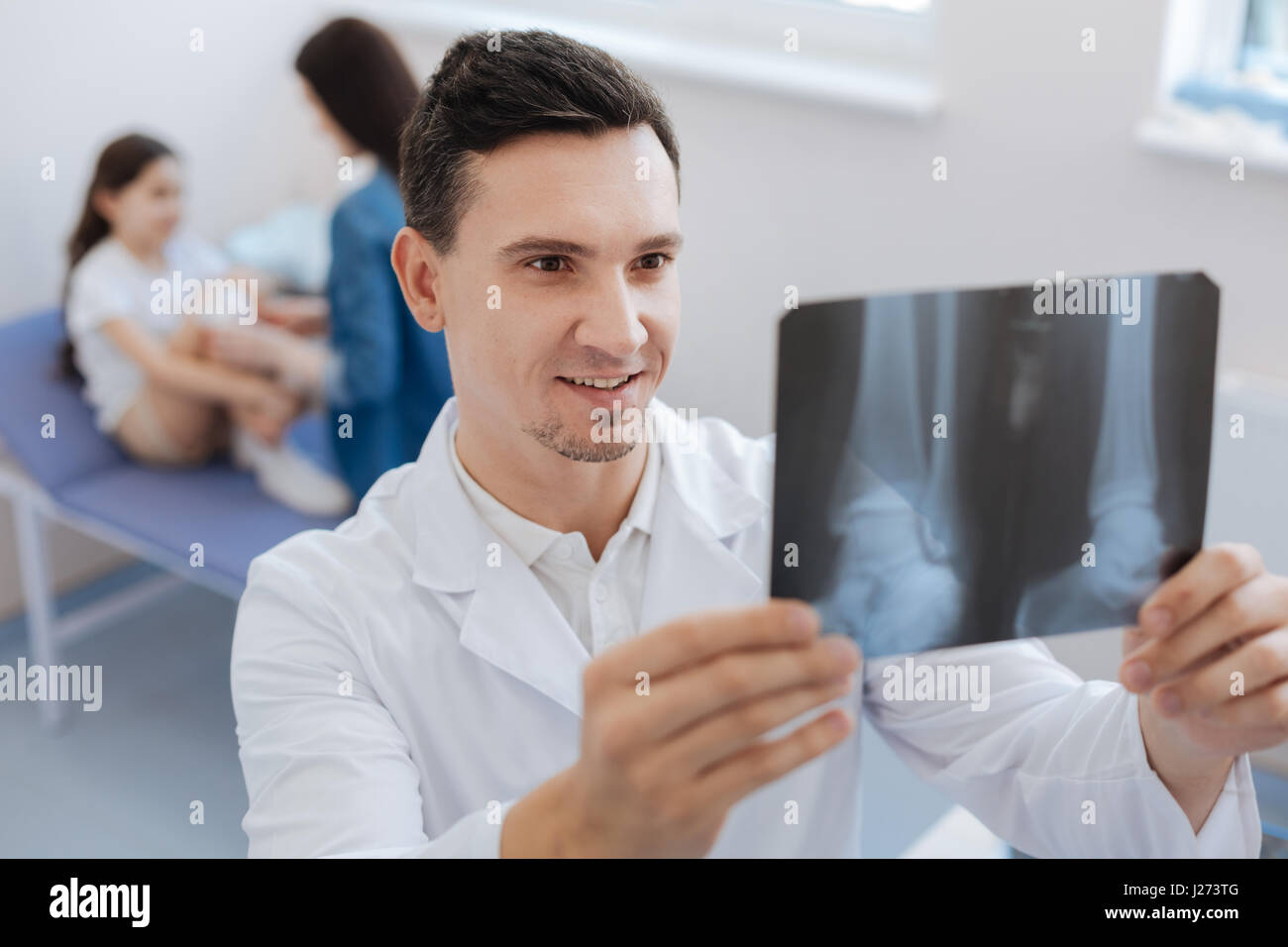 Nice delighted doctor being happy about his patient Stock Photo