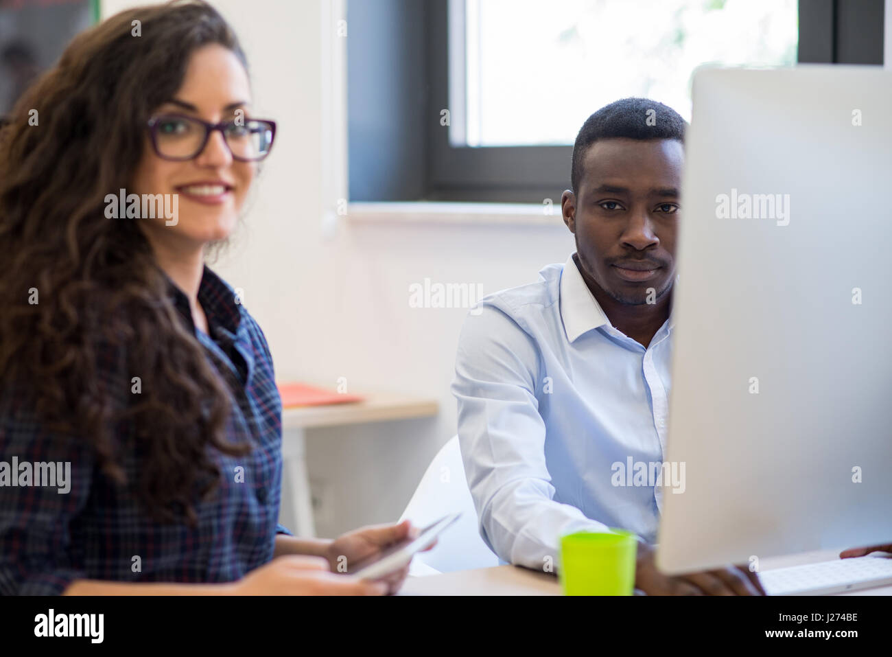 Multiethnic group of happy business people working with laptop computer ...