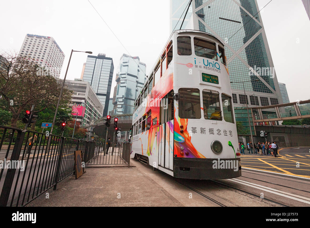 HONG KONG, APRIL 4, 2011 - Double-deck tram in front of skyscrapes. Wide angle shot. Stock Photo
