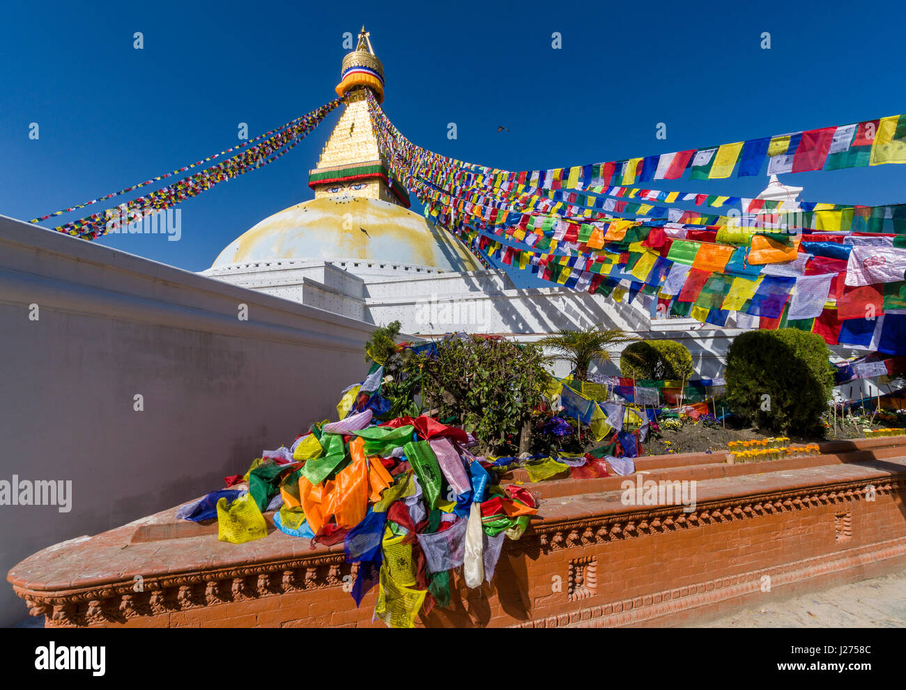 The Bouda Stupa is the centre of buddhist spirituality in town, the white building is decorated by colorful tibetean prayerflags Stock Photo