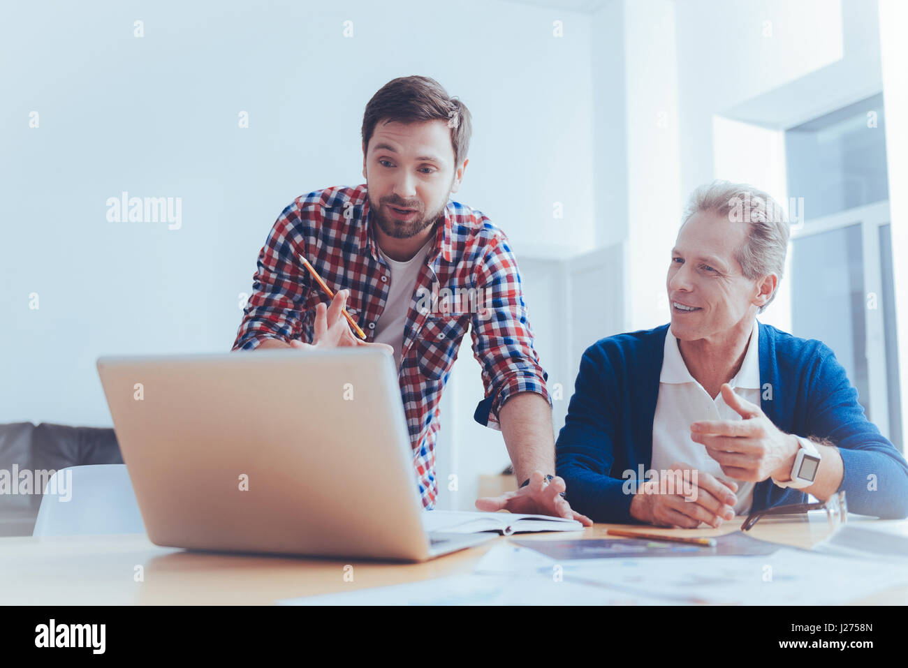 Pleasant involved colleagues workign on the project Stock Photo - Alamy