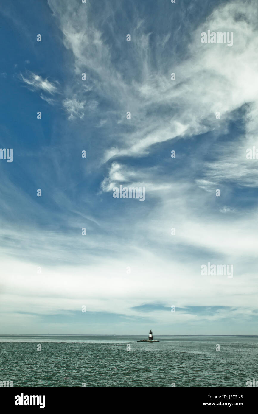 Seascape and dramatic clouds with Orient Point Lighthouse, Long Island, New York in the distance Stock Photo