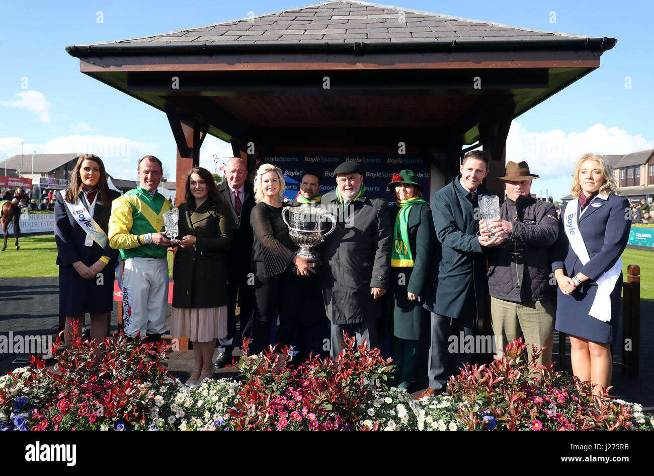 Jockey Robbie Power (second left) is presented with the trophy after riding Fox Norton to victory in the BoyleSports Champion Chase alongside owner Alan Potts (centre right) and trainer Colin Tizzard (second right) during day one of the Punchestown Festival in Naas, Co. Kildare. Stock Photo