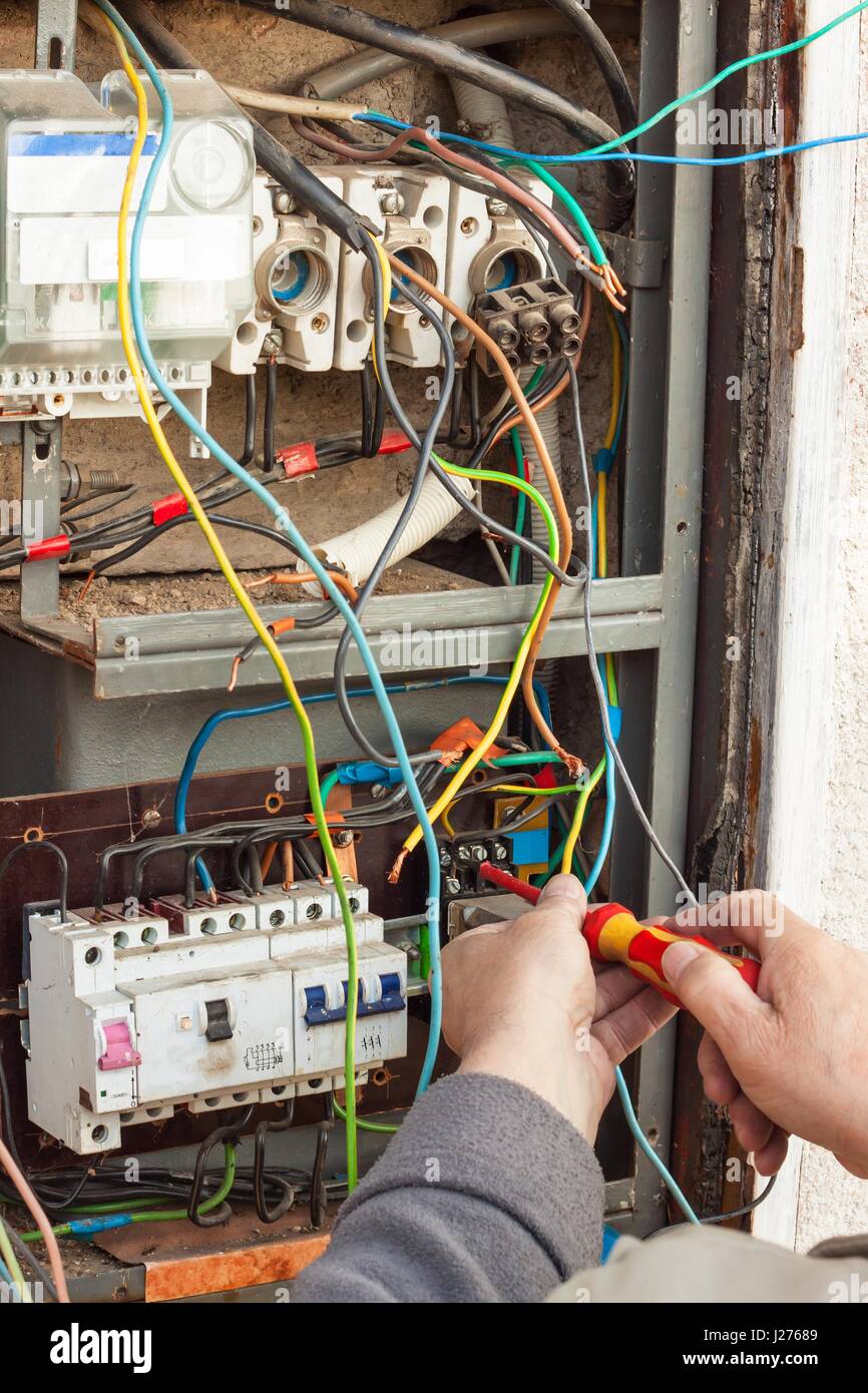 Repair of old electrical switchgear. An electrician replaces old
