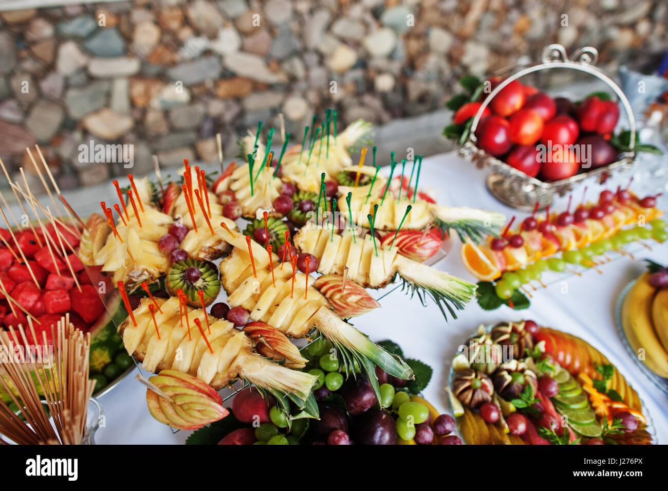 Table catering with different fruits such as watermelon, pineapple at