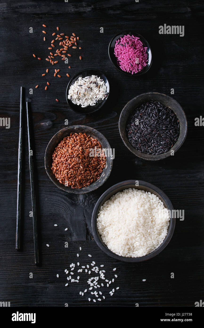 Variety assortment of raw uncooked colorful rice white, black, brown ...