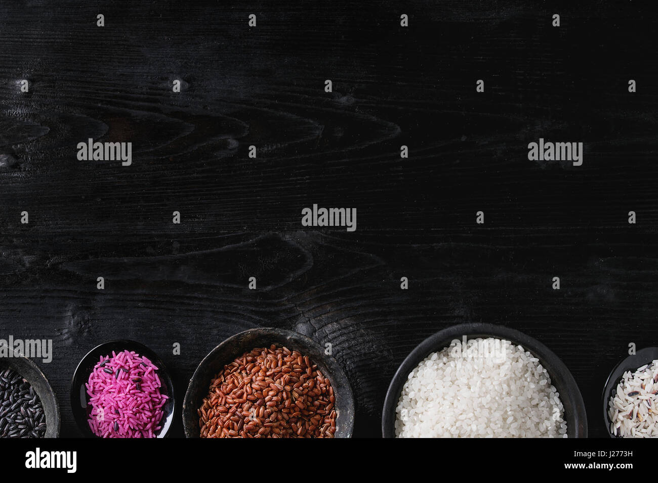 Variety assortment of raw uncooked colorful rice white, black, brown ...