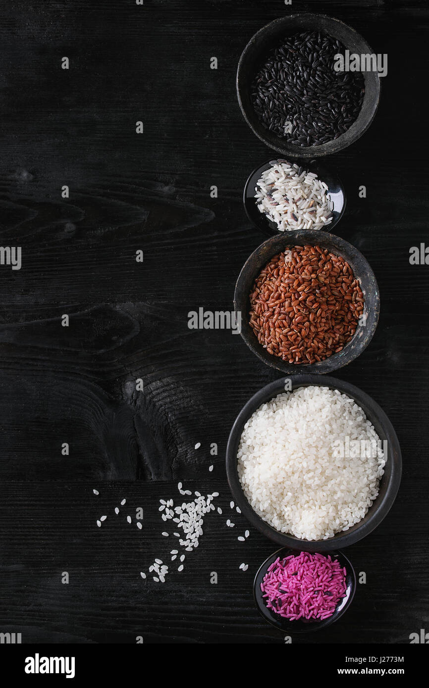 Variety assortment of raw uncooked colorful rice white, black, brown ...