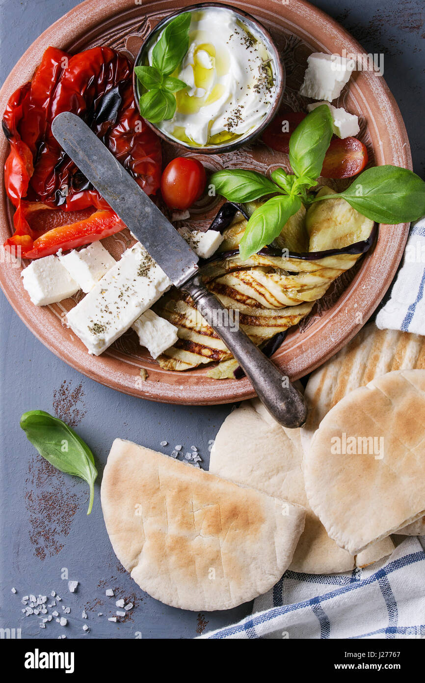 Ingredients for making pita bread sandwiches. Grilled vegetables, basil