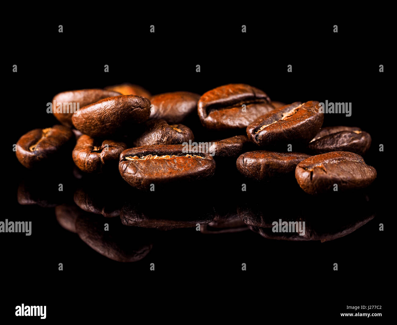 Roast coffee beans on the black background Stock Photo
