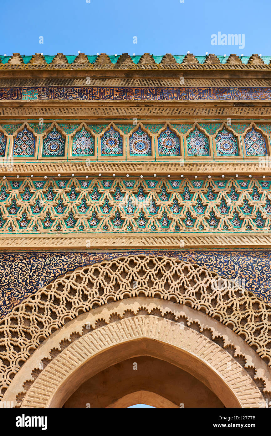 Zellij mosaics and arabesque Moorish plasterwork of the Bab Mansour gate. Named after the architect, El-Mansour, completed in 1732, Meknes Morocco Stock Photo
