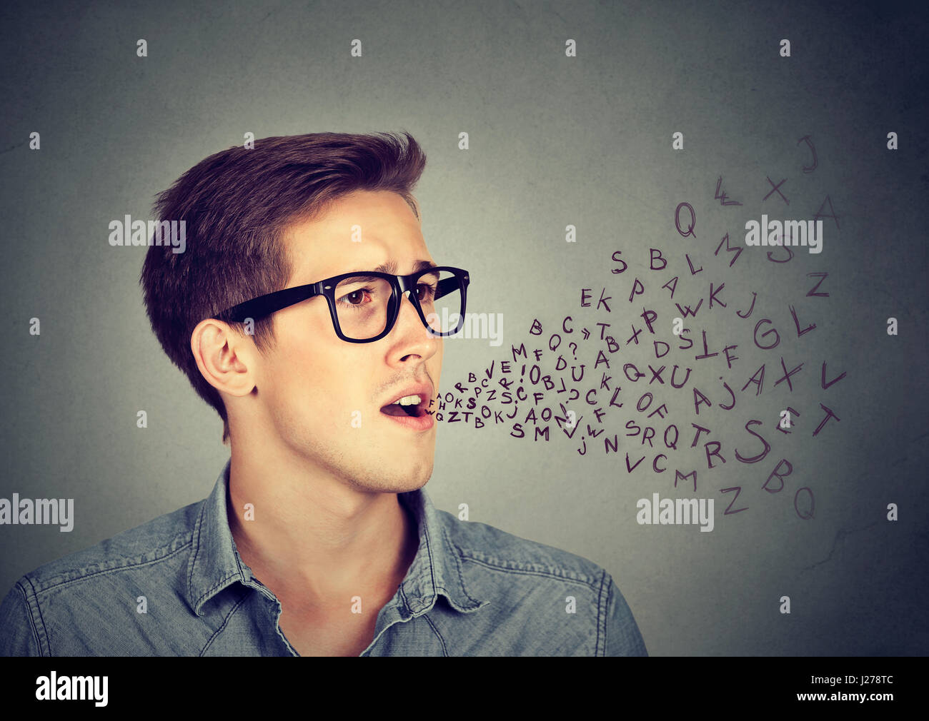 Side profile man talking with alphabet letters coming out of his mouth. Communication, information, intelligence concept Stock Photo