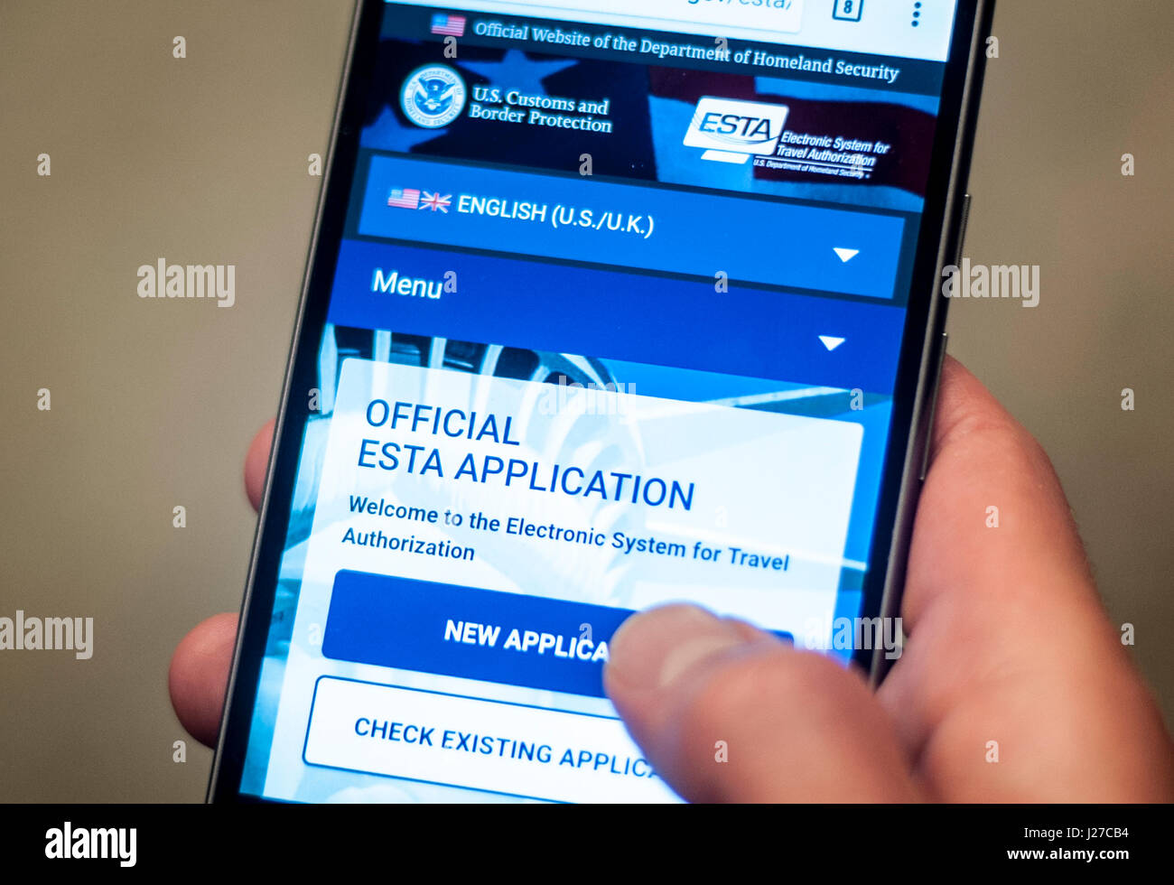 A man accessing the US Department for Homeland Security's official Esta visa waiver application website on his mobile phone. The scheme requires international travellers who are exempt from visa requirements to apply for an Esta, which stands for Electronic System for Travel Authorisation, and pay a small fee - around &Acirc;&pound;10 - before entering the territory. Stock Photo