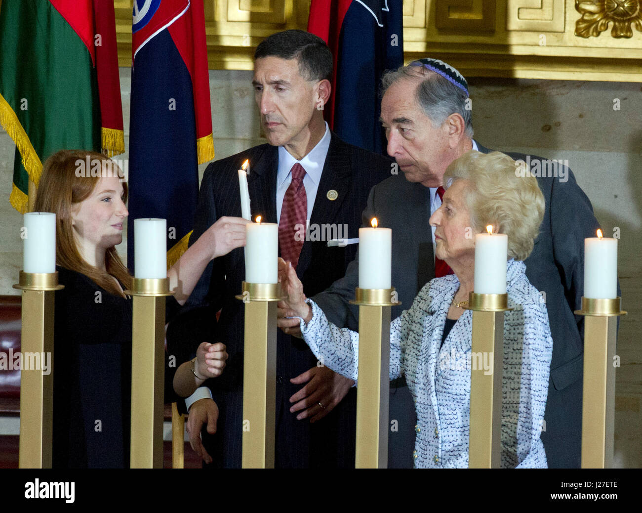 Washington, USA. 25th Apr, 2017. Participants in the candle lighting ceremony, from left to right: Shira Godin, a sophomore at the Charles E. Smith Jewish Day School in Rockville, Maryland; United States Representative David Kustoff (Republican of Tennessee); Emanuel Mandel, Holocaust Survivor; and Irene Weiss, Holocaust Survivor; following US President Donald J. Trump's remarks at the National Commemoration of the Days of Remembrance ceremony in the Rotunda of the US Capitol in Washington, DC on Tuesday, April 25, 2017. Credit: MediaPunch Inc/Alamy Live News Stock Photo