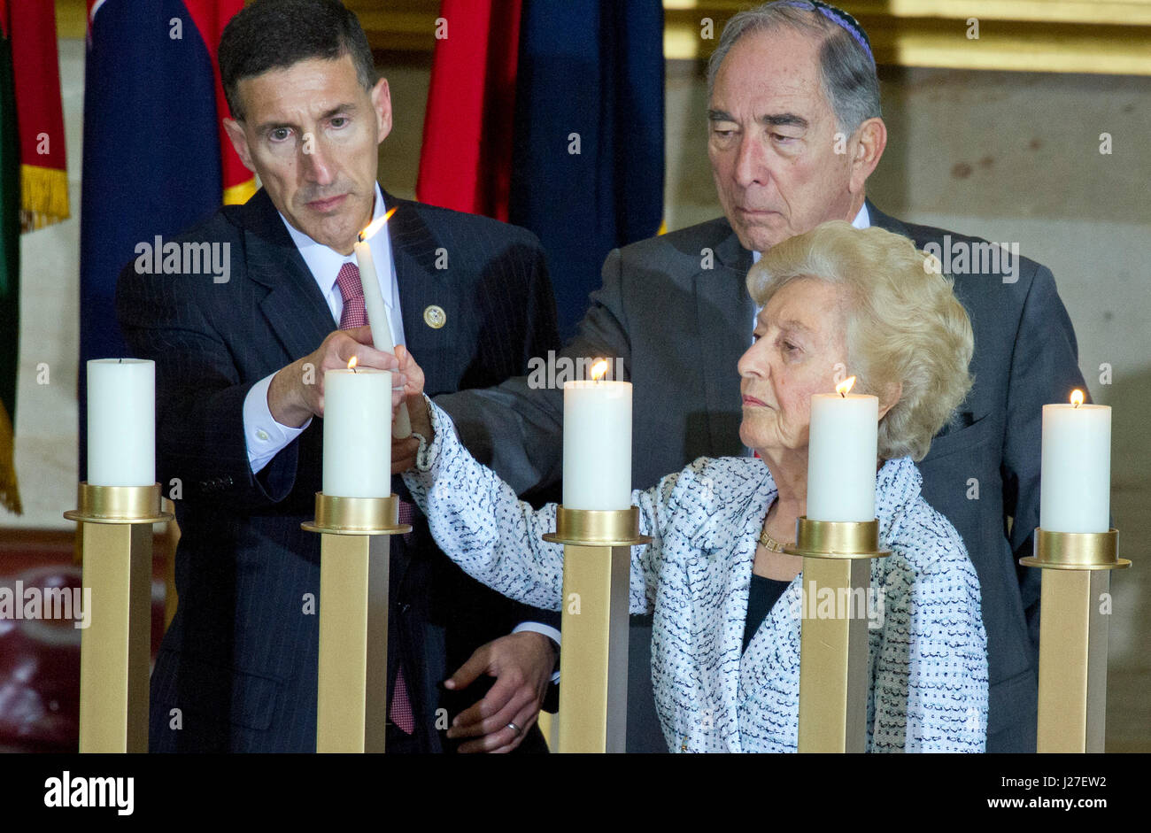 Washington, USA. 25th Apr, 2017. United States Representative David Kustoff (Republican of Tennessee), left, helps Irene Weiss, Holocaust Survivor, lower right, light a candle as Emanuel Mandel, Holocaust Survivor, center, looks on following US President Donald J. Trump's remarks at the National Commemoration of the Days of Remembrance ceremony in the Rotunda of the US Capitol in Washington, DC on Tuesday, April 25, 2017. Credit: MediaPunch Inc/Alamy Live News Stock Photo
