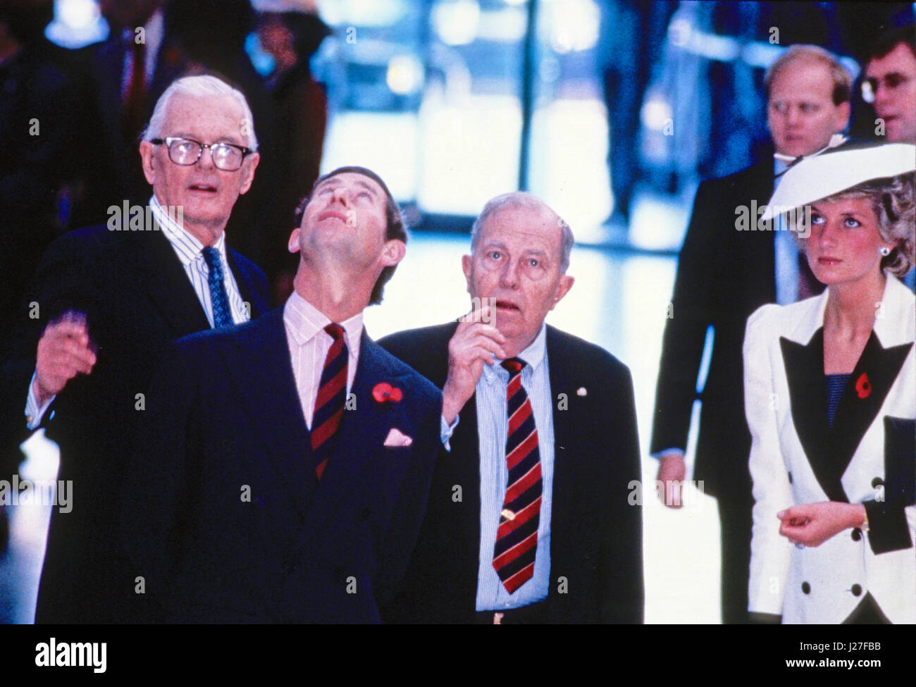Prince Charles looks up at a hanging exhibit above the center of the gallery as the Royal couple tours the exhibit 'The Treasure Houses of Britain: 500 Years of Private Patronage and Art Collecting' at the National Gallery of Art in Washington, DC on November 11, 1985. From left to right: John Stevenson, President of the National Gallery of Art; Prince Charles; Dr. Franklin Murphy, Board Chairman of the National Gallery of Art; and Princess Diana. Credit: Peter Heimsath/Pool via CNP - NO WIRE SERVICE- Photo: Peter Heimsath/Consolidated News Photos/Peter Heimsath - Pool via CNP Stock Photo