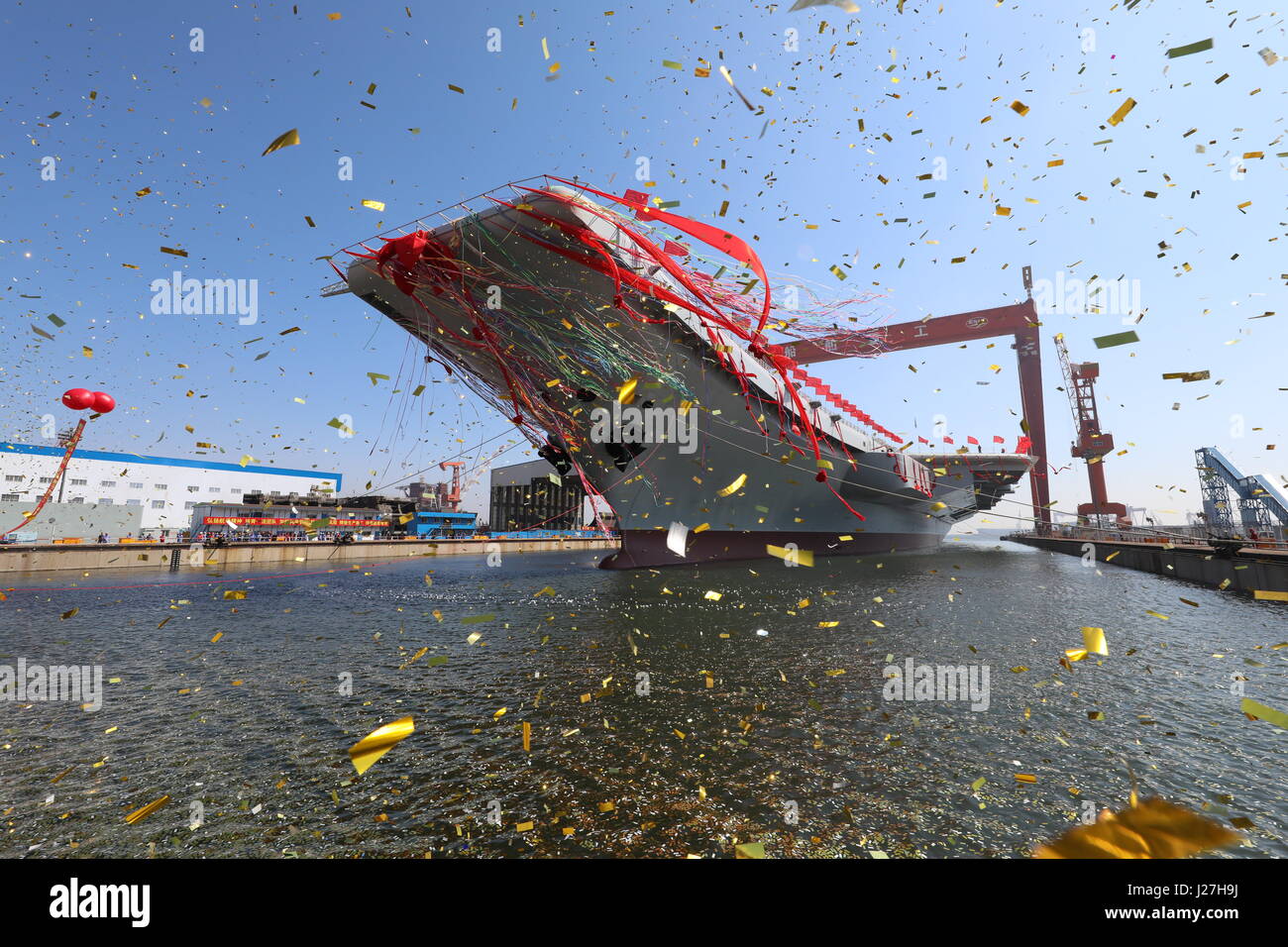 Dalian, China's Liaoning Province. 26th Apr, 2017. China's second aircraft carrier is transferred from dry dock into the water at a launch ceremony in Dalian shipyard of the China Shipbuilding Industry Corp. in Dalian, northeast China's Liaoning Province, April 26, 2017. The new carrier, the first domestically-built one, came after the Liaoning, a refitted former Soviet Union-made carrier that was put into commission in the Navy of the Chinese People's Liberation Army in 2012. Credit: Li Gang/Xinhua/Alamy Live News Stock Photo
