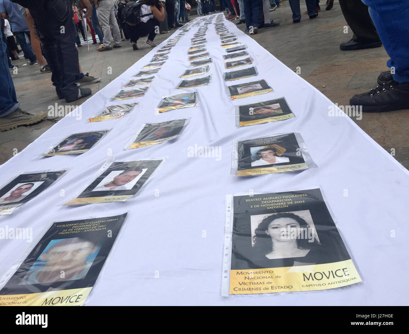 Medellin, Colombia. 06th Mar, 2017. Lying on a long, white cloth in Plaza Botero in Medellin, Colombia, 06 March 2017, can be seen pictures of hundreds of people suspected murdered by the country's paramilitaries and guerrillas, a reminder that the fates of many still remain unknown. Photo: Georg Ismar/dpa/Alamy Live News Stock Photo