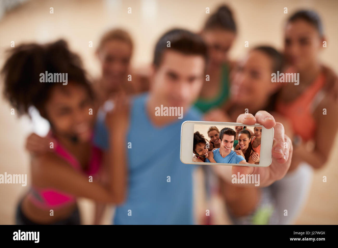 Selfie of young fitness group, close up of mobile phone Stock Photo