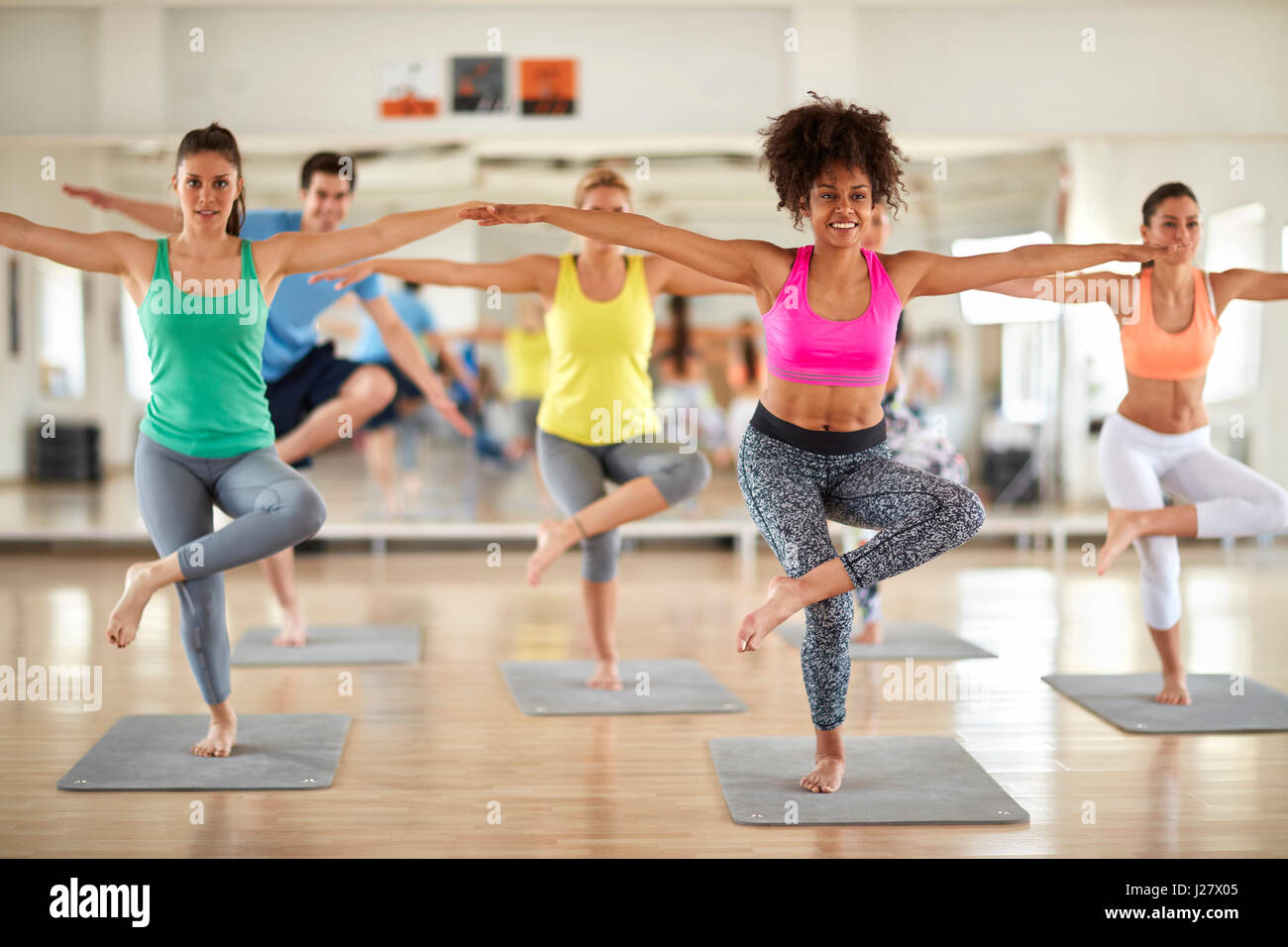 Group of young sport people have body balance training in gym Stock ...