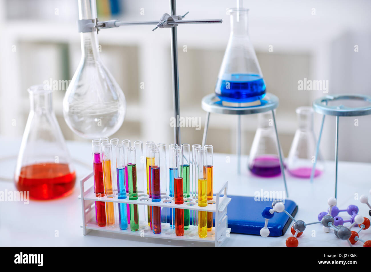 desk in chemistry lab with samples in test tubes and equipment Stock Photo