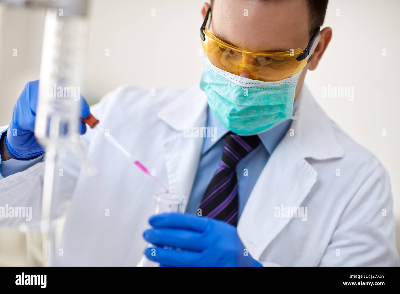 Scientist performing experiment in chemistry lab Stock Photo