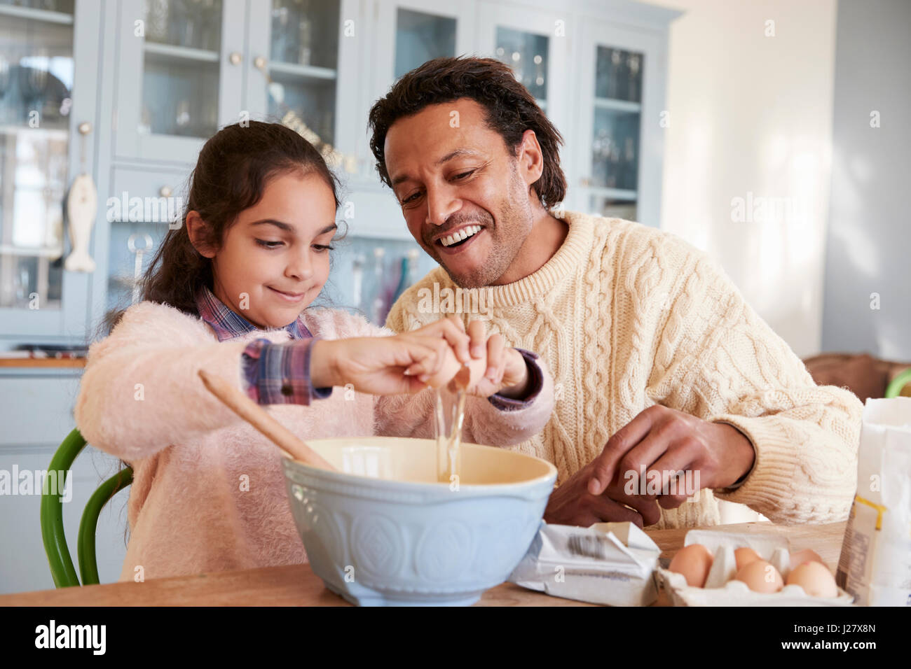 Father And Daughter Baking Cookies At Home Together Stock Photo