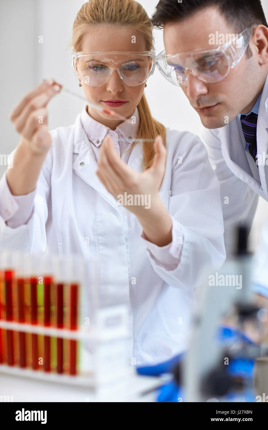 Two young medical researcher doing microbiology experiment Stock Photo
