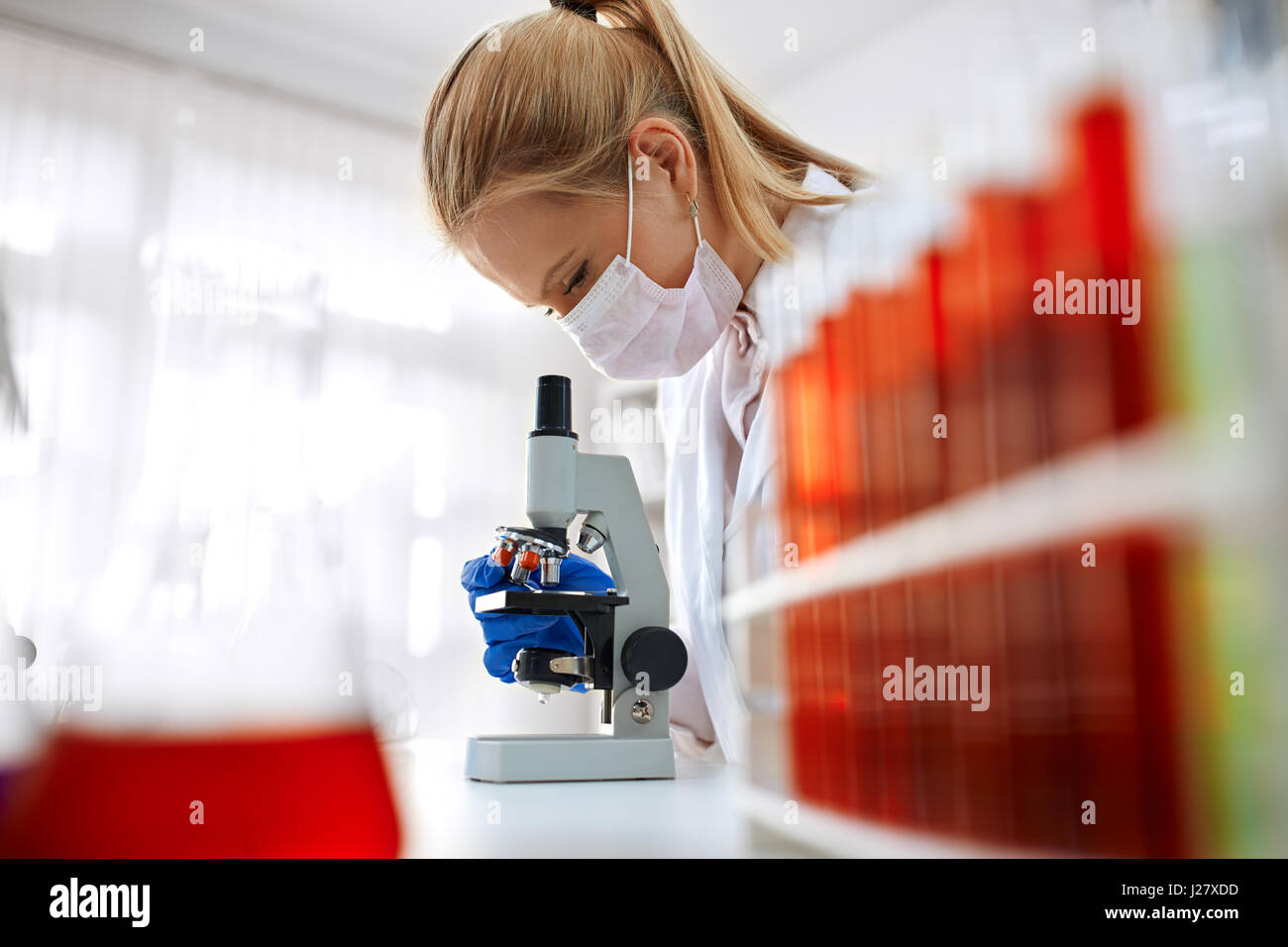 Microscope laboratory - woman medical research chemist experiment Stock Photo