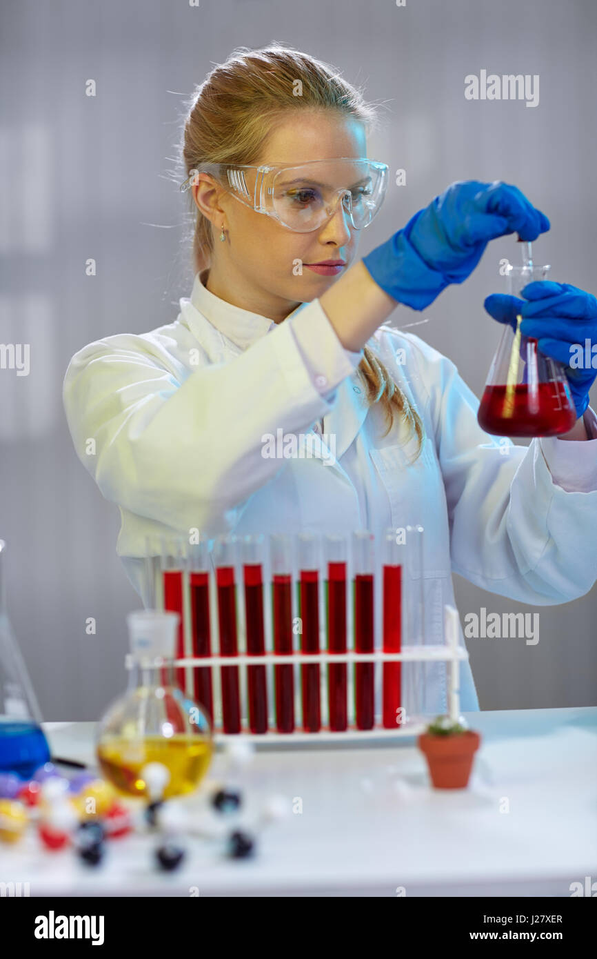 Young female scientist works in modern biological lab Stock Photo