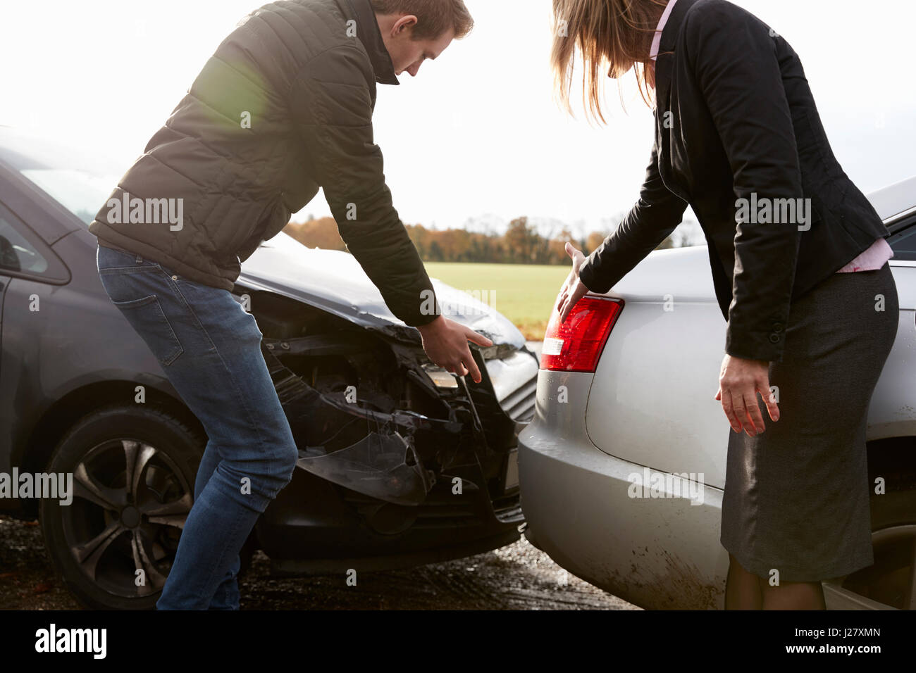 Two Drivers Arguing Over Damage To Cars After Accident Stock Photo