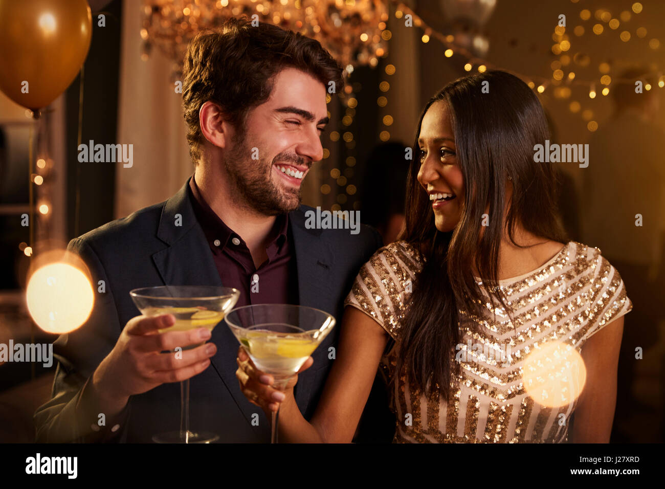 Couple Make Toast As They Celebrate At Party Together Stock Photo
