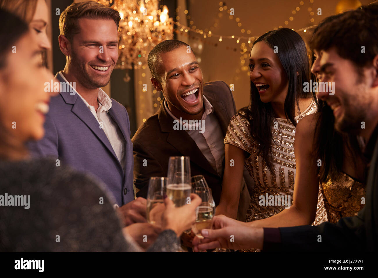 Friends Make Toast As They Celebrate At Party Together Stock Photo