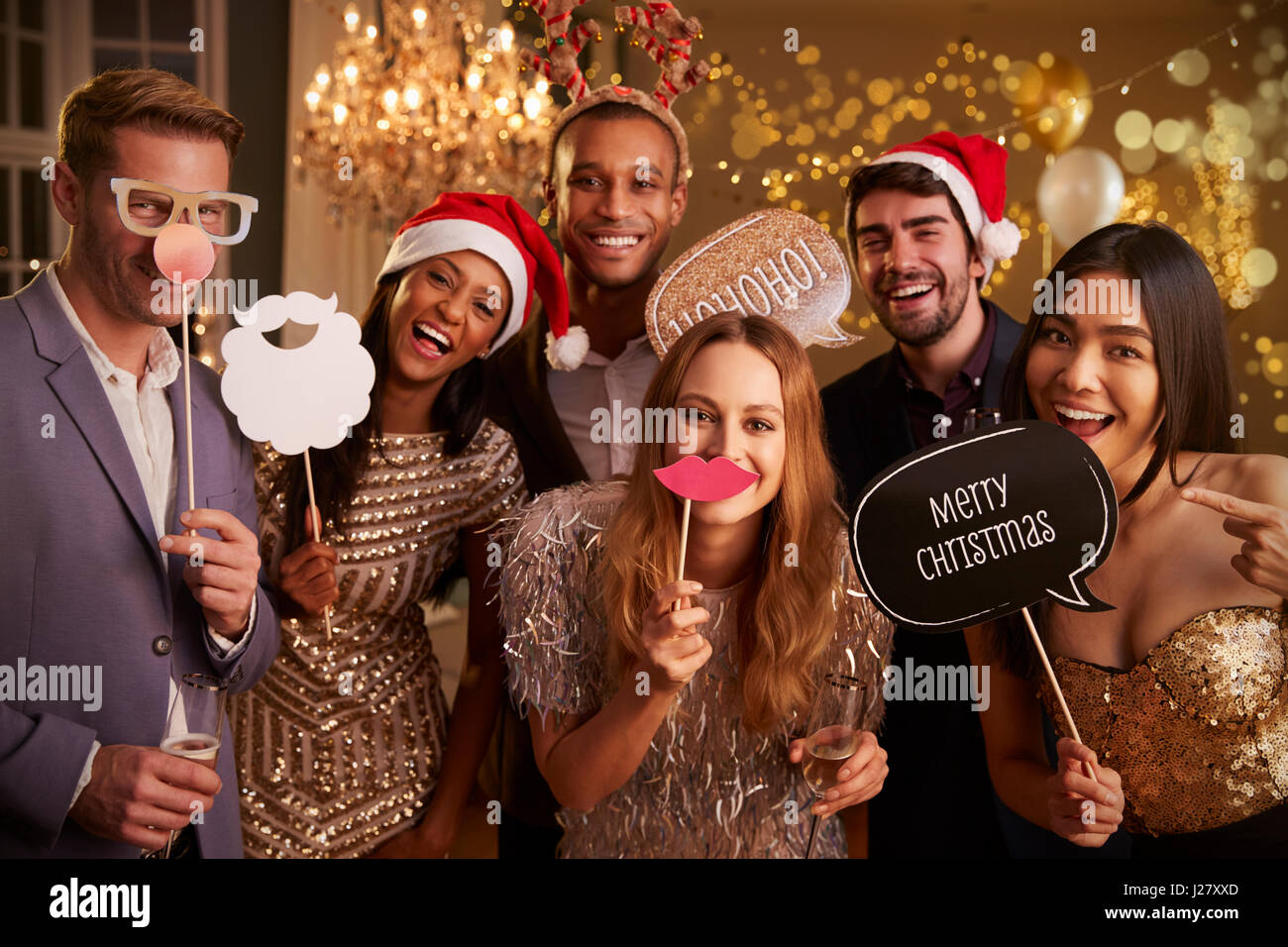 Group Of Friends Dressing Up For Christmas Party Together Stock Photo