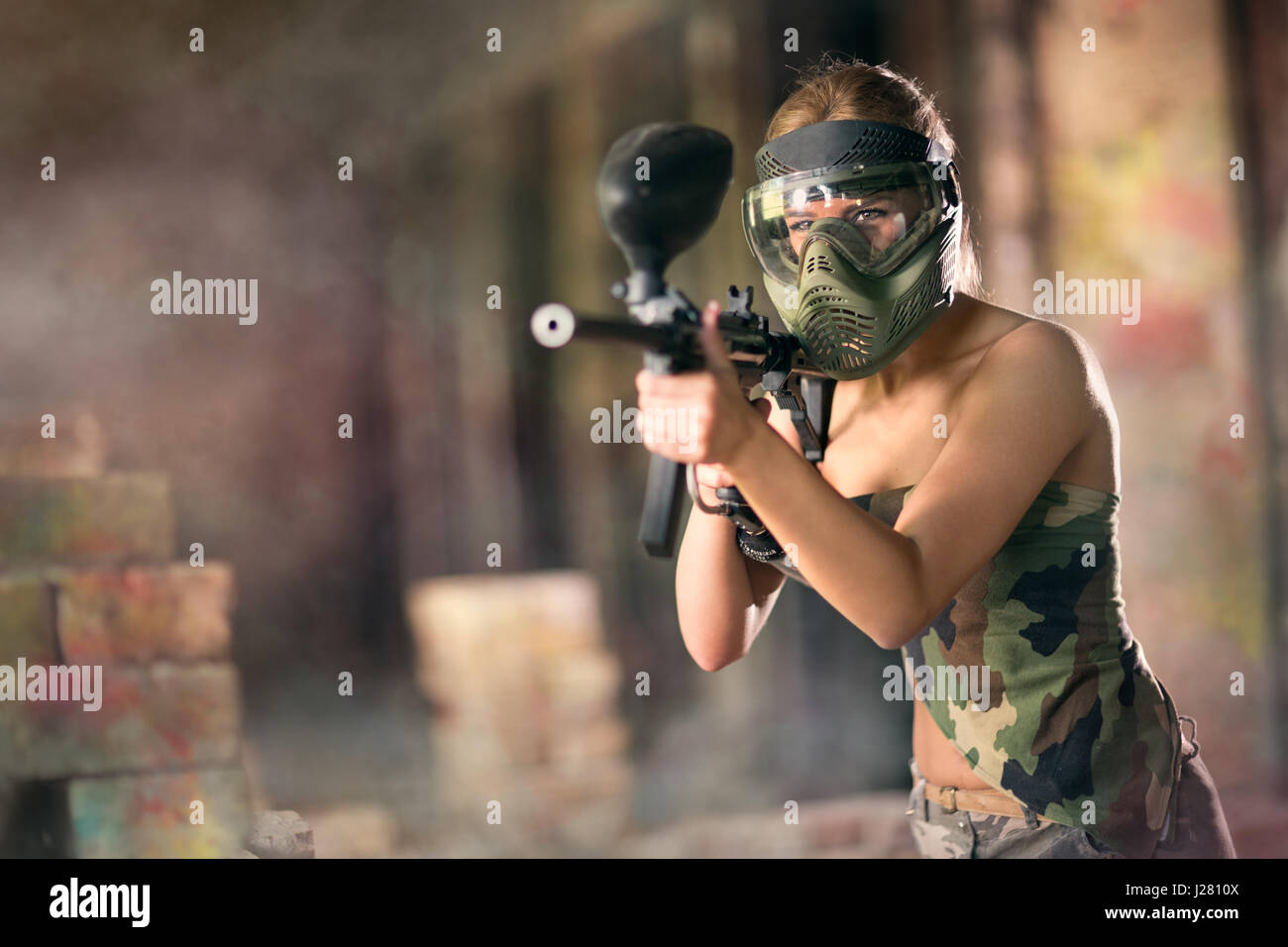 Paintball, female player with marker gun Stock Photo
