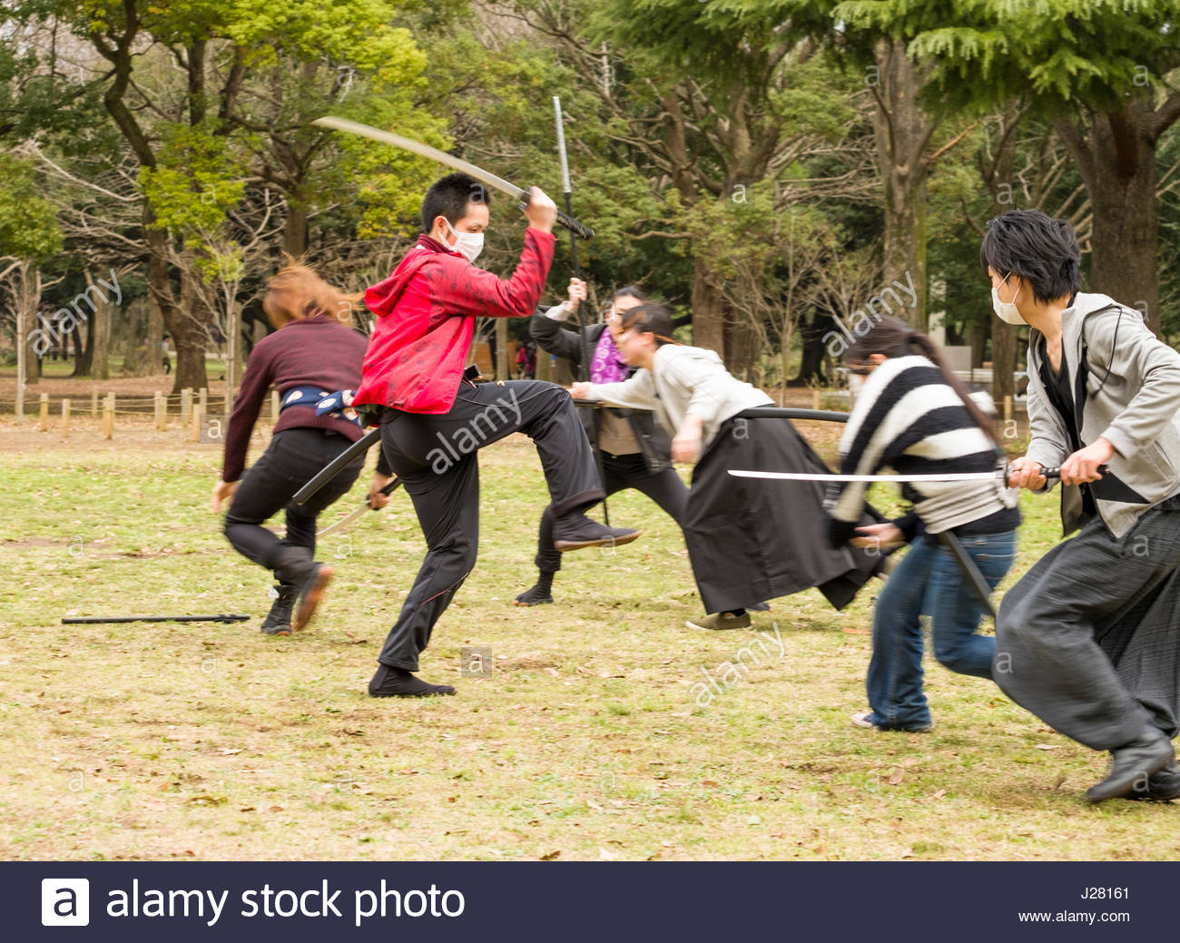 group-of-japanese-people-practicing-choreographed-sword-fighting-in-J28161.jpg