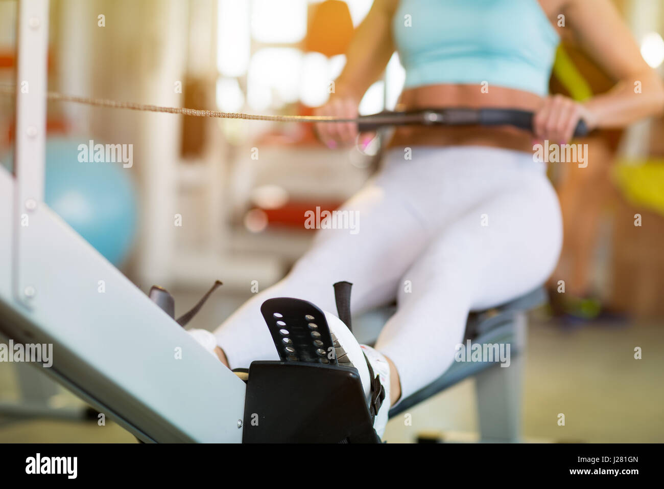 Fit girl doing exercise at the gym Stock Photo