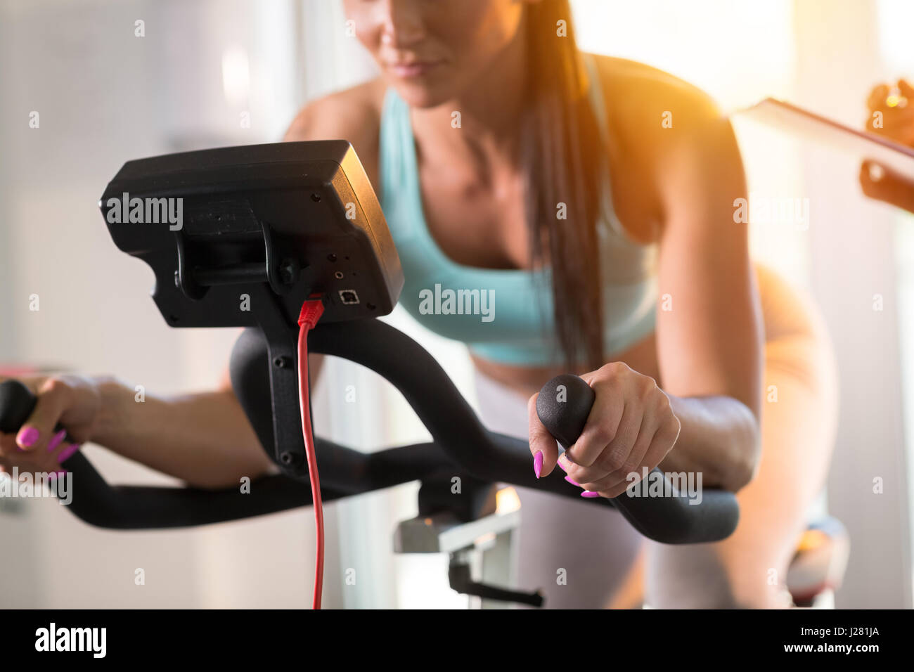 Young women doing sport biking in the gym for fitness Stock Photo