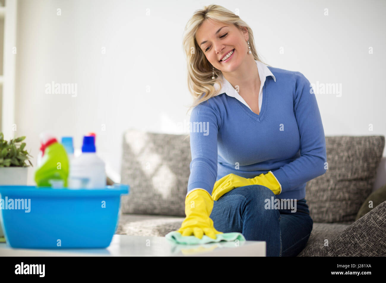 Housewife begins cleaning houses with cleaning products Stock Photo