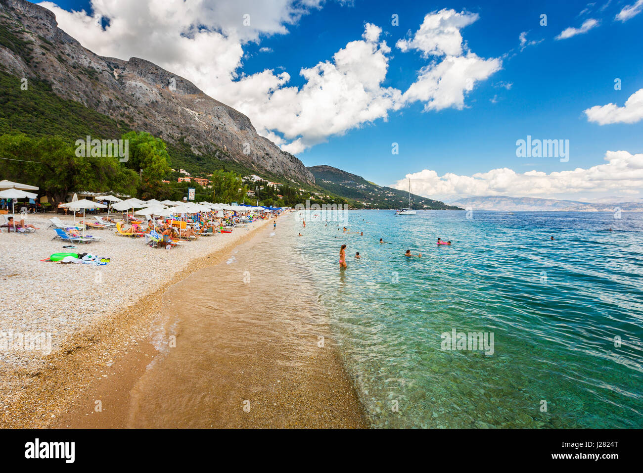 Corfu, Greece -August 20, 2015: Beautiful beach in Barbati on Corfu, tourists enjoying a nice summer day at the beach. Kerkyra (Corfu), Greece Stock Photo
