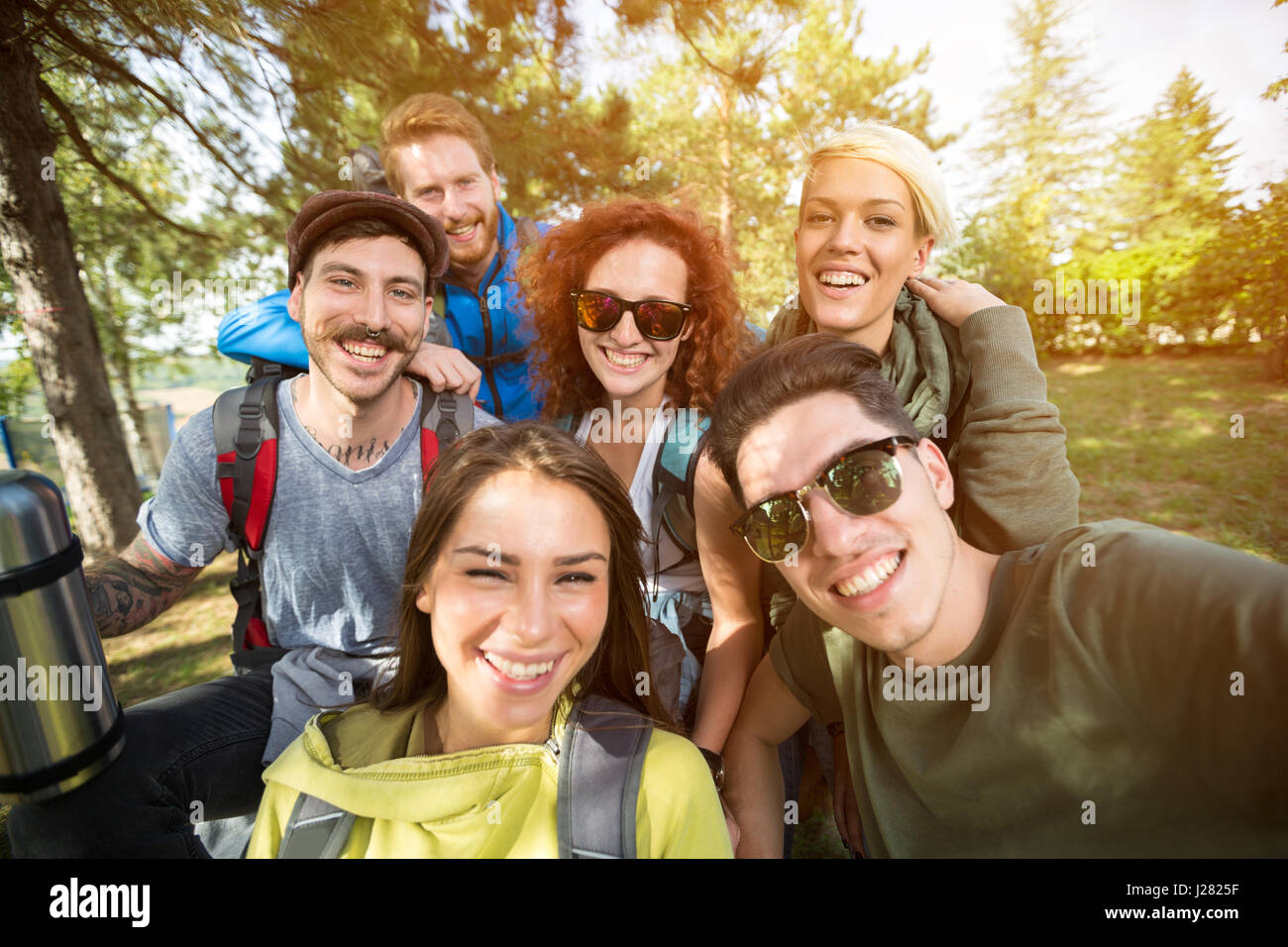 Group photo of cheerful smiling hikers in woods Stock Photo - Alamy