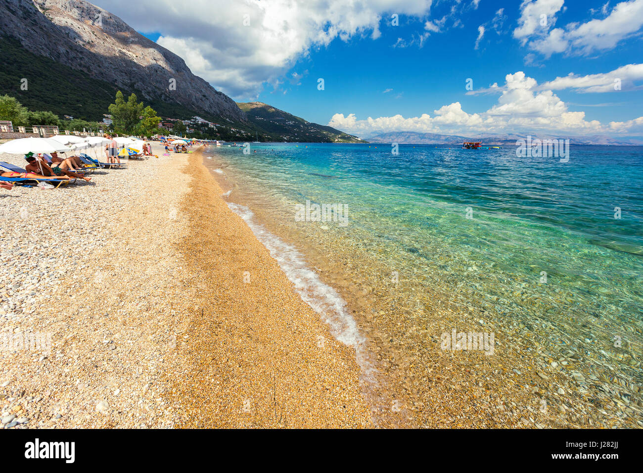 Corfu, Greece -August 20, 2015: Beautiful beach in Barbati on Corfu, tourists enjoying a nice summer day at the beach. Kerkyra (Corfu), Greece Stock Photo