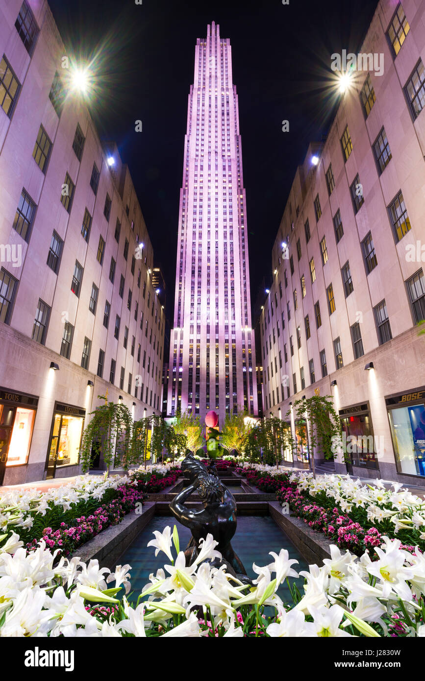 Rockefeller Plaza flower garden and pond lit up at night, Manhattan, New York, USA Stock Photo