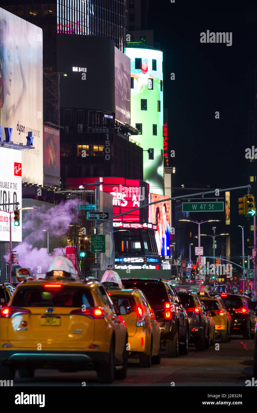 Times Square Taxis Lined Up Waiting At Traffic Lights At Night, New York Stock Photo