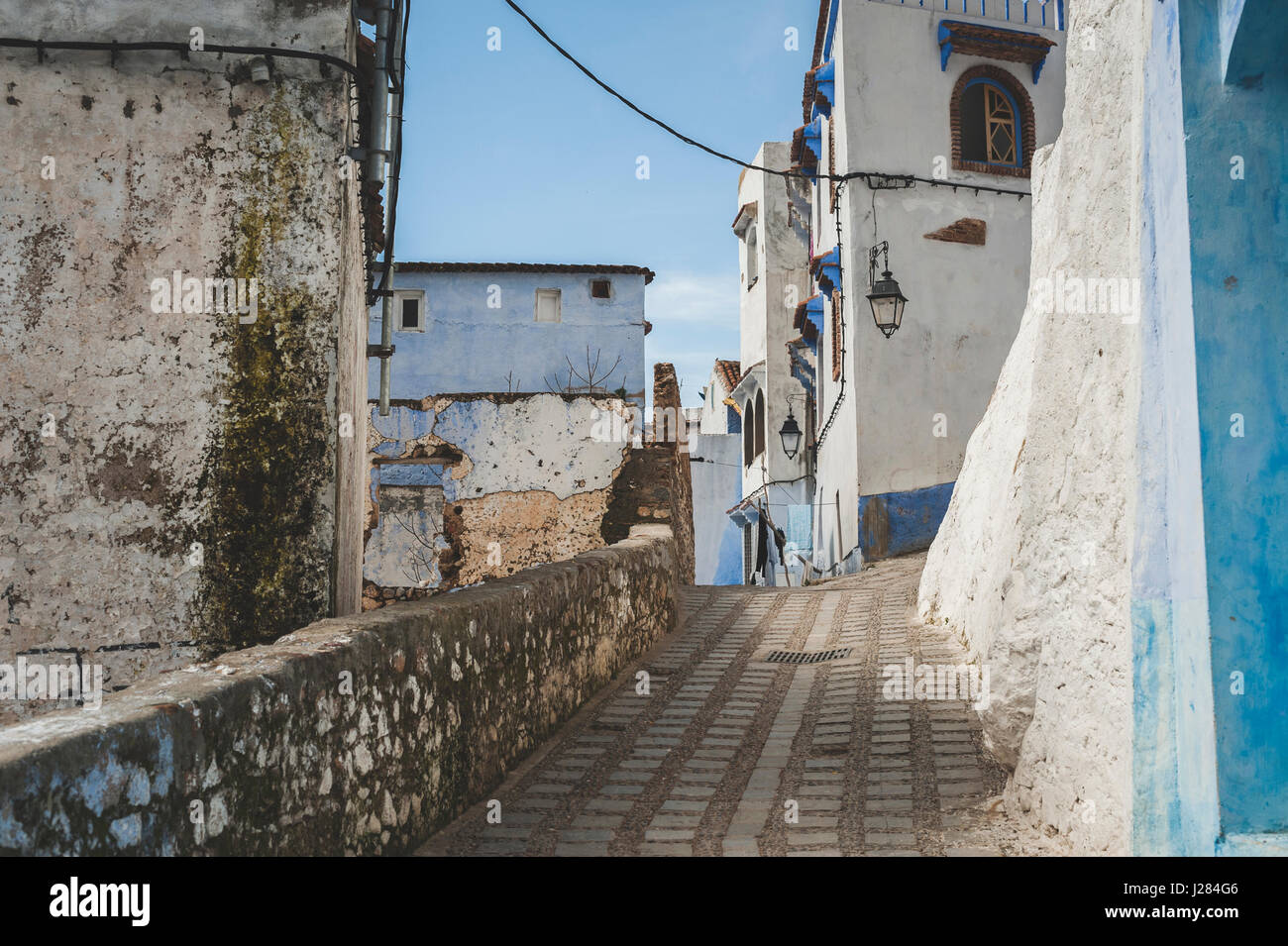 Empty alley by buildings in town Stock Photo